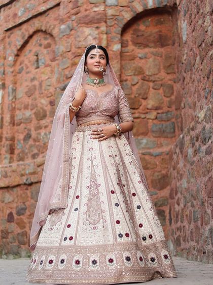 The bride looking stunning in her pastel lehenga. This outfit is a testament to the fact that you don't have to wear red to look like a bride.