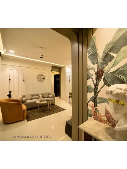 The entrance of the Sushil Advait project opens up to this beautiful living room. The tropical wallpaper and classical bust create a unique and artistic first impression.