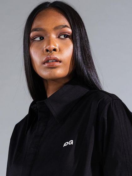 A close-up from a commercial fashion shoot, demonstrating a natural yet defined makeup look. The skin is perfected, and a soft liner enhances the eyes without overpowering the shot.