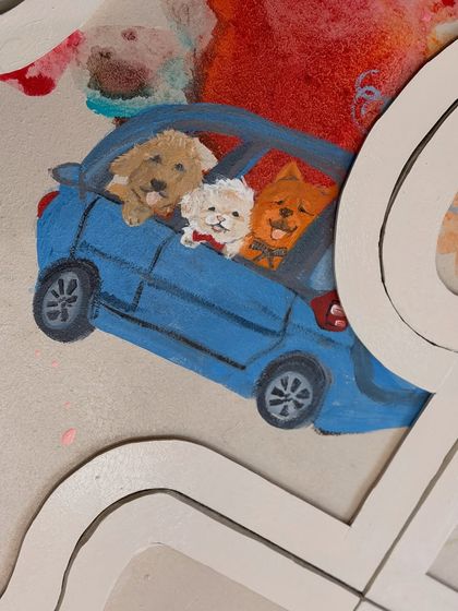 A close-up on a particularly sweet detail. This miniature painting captures the client's three dogs on a car ride, a memory they wanted to feature prominently in their custom relationship artwork.