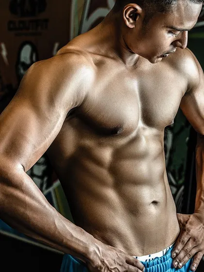 A closer look at the "after" physique. The vascularity and muscle separation in the arms and chest are clear indicators of a successful cutting phase.