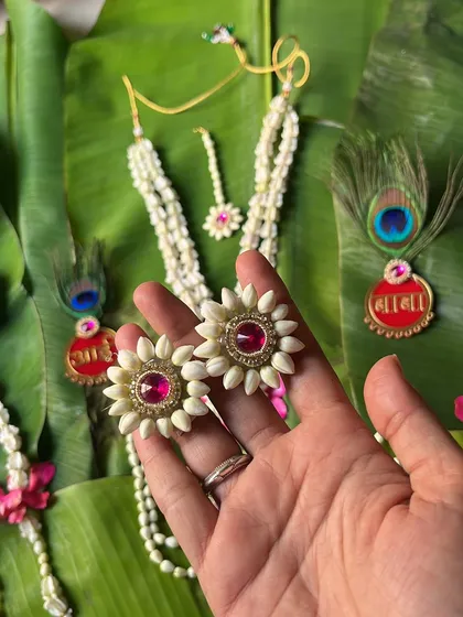 A close-up of the handcrafted floral earrings from a baby shower set. The detail in each petal and pearl is what makes my jewellery special.