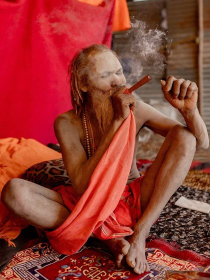 Ambassador Baba, a Naga Saint from Indore, smokes his chillum. He is famous for traveling the country for 35 years in his saffron-colored 1972 Ambassador car.