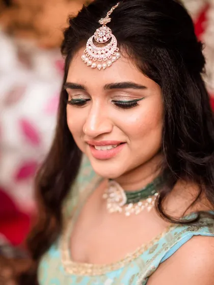 A soft and pretty close-up. The makeup is subtle and enhances her natural features, perfect for daytime events like a Mehendi ceremony.