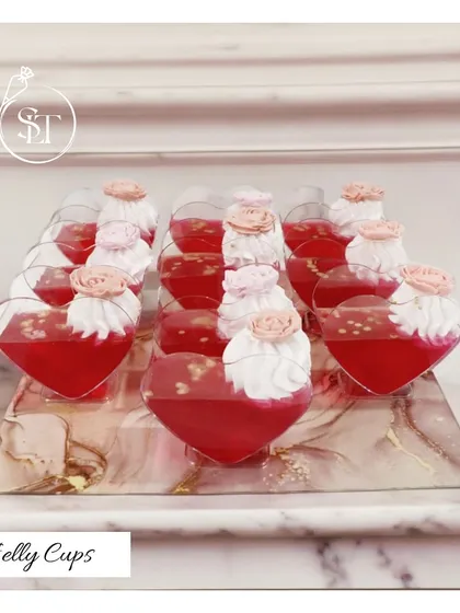 These lovely heart-shaped Jelly Cups are a sweet and light dessert option. The vibrant red jelly is topped with a swirl of fresh cream and a delicate sugar rose, making them perfect for a romantic occasion.