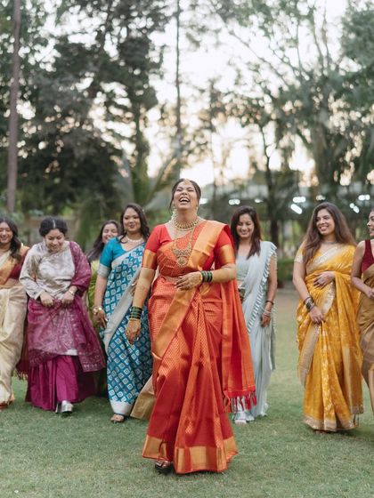 The bride and her bridesmaids share a moment of pure, uninhibited laughter. This shot is full of energy and captures the beautiful bond of friendship.