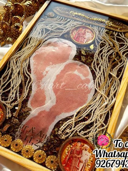 A close-up of a frame featuring preserved 'griha pravesh' footprints, surrounded by the groom's sehra and other wedding mementos. A truly unique and sentimental piece.