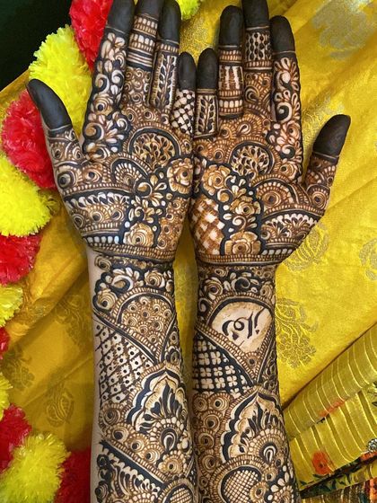 The full design from palms to forearms, featuring a mix of personal elements and traditional patterns.