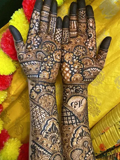The full design from palms to forearms, featuring a mix of personal elements and traditional patterns.