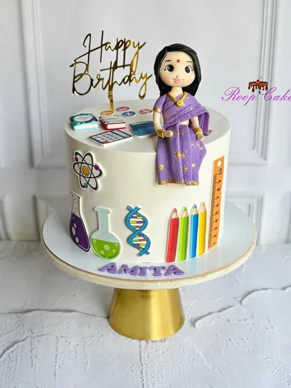 A sweet tribute to a teacher's passion for learning. This cake is decorated with a custom fondant figurine in a beautiful saree and various edible educational symbols.