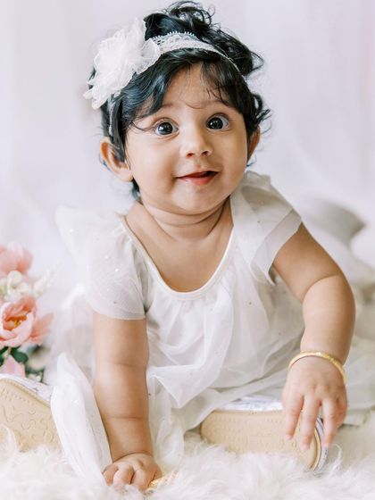 A close-up of the six-month-old's bright, curious eyes. She is absolutely captivating.