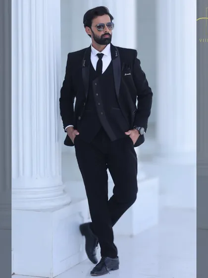 You can never go wrong with a classic. This is our bespoke all-black three-piece suit, custom-stitched for a sharp, flattering silhouette. It's a versatile and essential piece for any man's formal wardrobe.