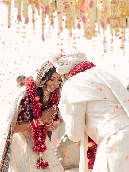 A moment of pure joy during the varmala ceremony. Kavi's makeup was designed to be waterproof and long-lasting, holding up beautifully through all the emotional and happy moments.