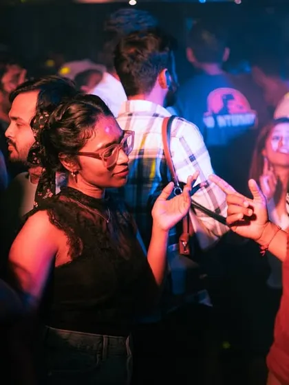 People connecting and talking on the dancefloor between songs.