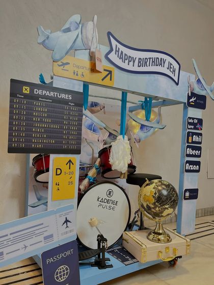 Another angle of the airport-themed hamper, showing the 'Departures' board listing exciting destinations and the 'Happy Birthday Jeh' banner.