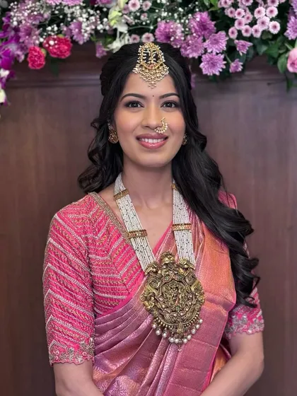 A radiant, smiling portrait that shows off her stunning antique pendant.