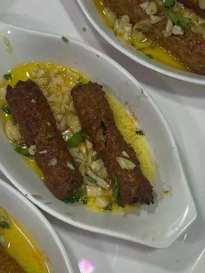 A photo of our Butter Garlic Seekh Kebab, paired with a delighted 5-star review. It's always a pleasure to see our food being enjoyed.
