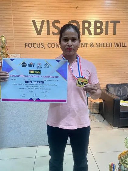 Holding my certificate and medal after being the overall winner at the Sheru Classic. This was a huge achievement in my powerlifting journey.