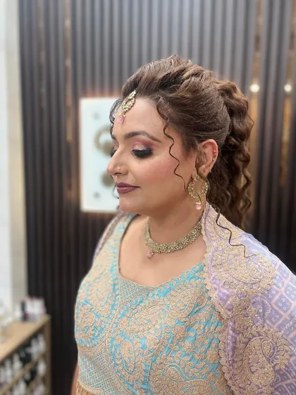 A close-up of the makeup that goes with the curly ponytail hairstyle, featuring a soft smokey eye and a glossy lip.