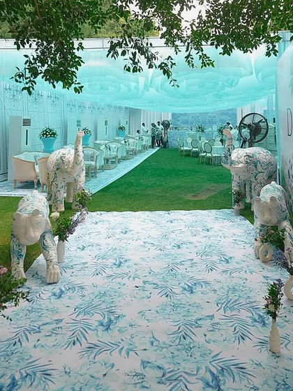 For a bride who loves high fashion, I designed a Mehendi inspired by Dior's iconic patterns. This entrance features custom-painted animal sculptures, setting the stage for a chic, couture-themed afternoon.