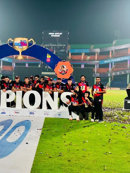 Another shot of the team on the champions' podium, soaking in the victory.
