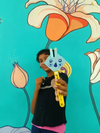 A young girl proudly displays her bunny craft. After a story session, these activities help children connect with the story's themes on a deeper level, turning abstract ideas like hope and rebirth into something they can hold.