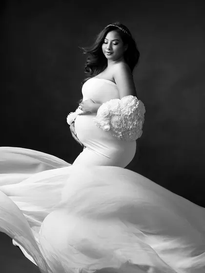 The flowing white gown takes on a new, dramatic quality in black and white. The contrast between light and shadow is just stunning.