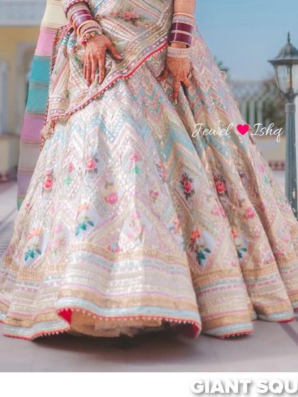 A detailed shot of the bride's stunning, multi-colored embroidered lehenga skirt.