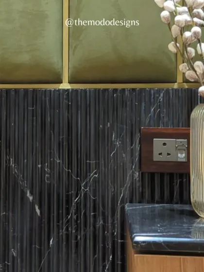 A close-up on the interplay of textures. Here, we combined fluted black marble, olive green velvet panels, and brass inlays to create a rich and tactile surface.