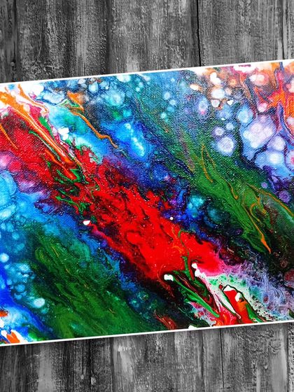 An abstract fluid art piece with a diagonal composition, blending red, green, and blue with beautiful cellular reactions.