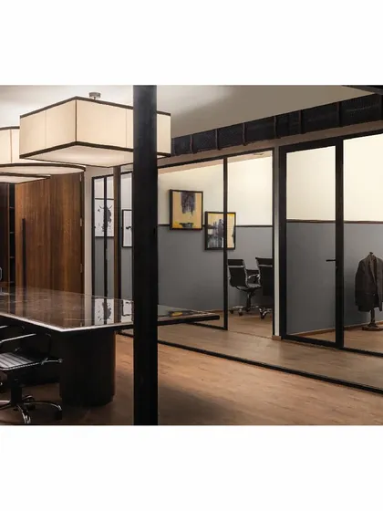 The conference room and cabins in the 'Shadows' project feature dark furniture and grey walls. This palette creates a formal and modern environment, moving away from the look of traditional legal offices.