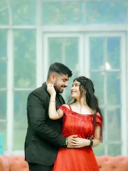 A joyful, candid moment of the couple sharing a look of love. The soft, bright background adds to the lighthearted and happy atmosphere of the shot.
