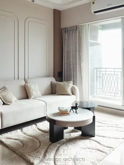 This bright and airy living room at Sai World Empire opens onto a balcony, flooding the space with natural light. The neutral color scheme enhances the sense of spaciousness and tranquility.