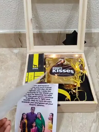 Here you can see a personal letter being added to the wooden box hamper, making the gift even more meaningful for the recipient.
