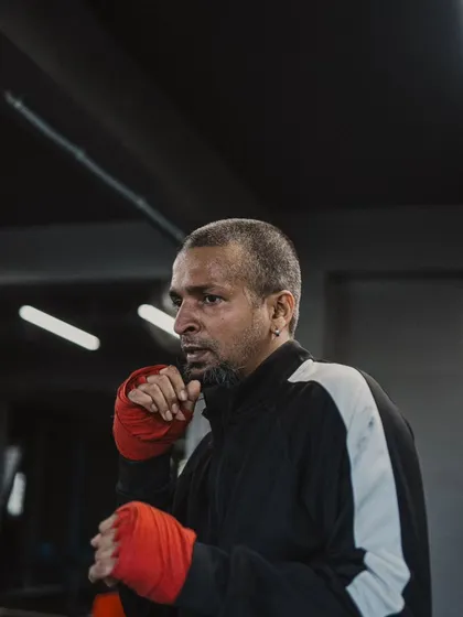 A fighter with his hands wrapped, focused and ready for shadowboxing or pad work.