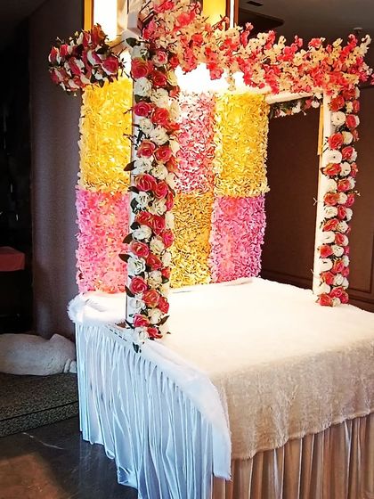 A side view of the floral Ganpati mandap, showing the structure and the arrangement of the flower garlands on the pillars.