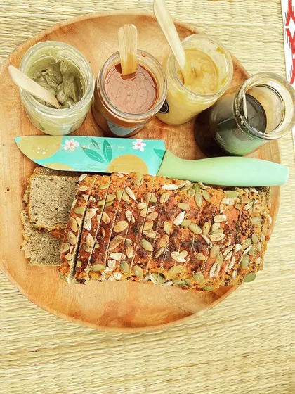 A beautiful platter showcasing the versatility of my products. Enjoy my lentil bread with a selection of savory and sweet spreads for a complete tasting experience.
