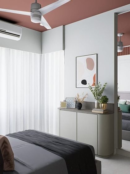 A modern minimalist bedroom where a large mirror reflects the space, making it feel larger and brighter. The clean lines and muted color palette create a sense of calm and order.