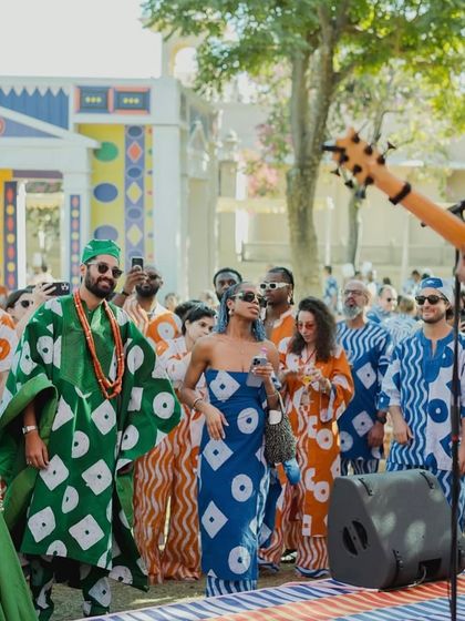 Guests enjoying the music at 'The Roots' Mehendi, all dressed in custom Asoebi-inspired fabrics. This created a vibrant sea of coordinated fashion that harmonized perfectly with the decor.