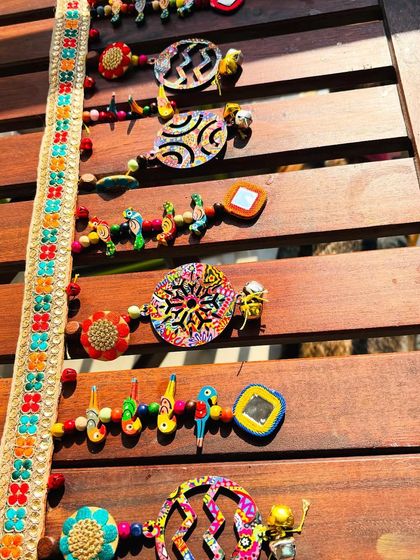 Another perspective of the 'Rang-Tarang' toran, capturing the sunlight on its vibrant colors and textures.