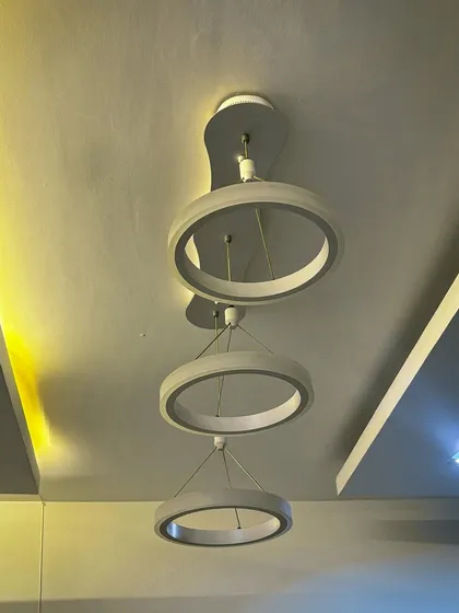 The same ring chandelier shown with warm lighting, demonstrating how the color temperature can change the mood of the room. I help clients choose the right lighting for their space.
