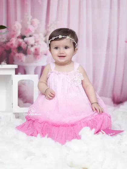A beautiful, bright smile from our little Barbie fan. The soft pink backdrop and fluffy clouds create a dreamy atmosphere for this portrait.