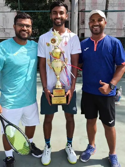 The coaching team celebrating with Anup Bangargi after his doubles victory in the men's open tournament.