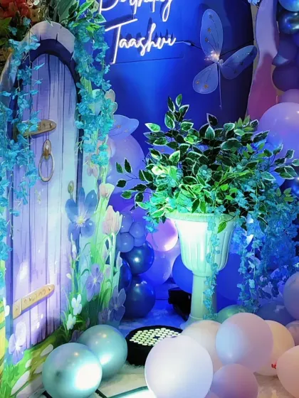 Detailed view of a fairy-themed birthday, showing the combination of props, greenery, and a custom neon sign.