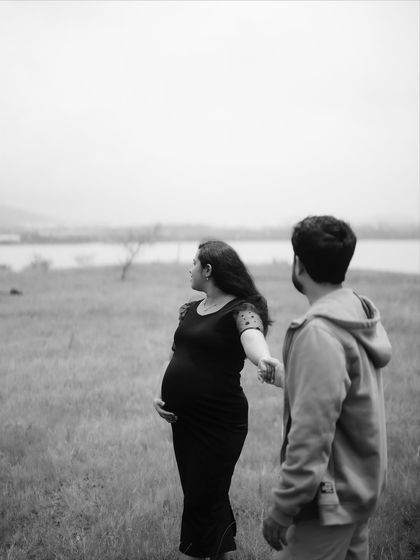 A black and white photo of the couple looking out towards the water together. It’s a quiet, contemplative moment, holding hands as they look toward their future.