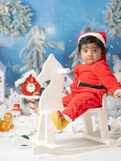 A little one's first Christmas. My festive mini sessions include adorable Santa outfits and a winter wonderland setup to capture this special milestone.
