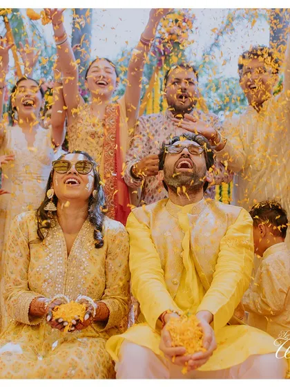 Another angle of the 'phoolon ki haldi,' capturing the ecstatic expressions of the couple and their friends. It’s a moment of collective happiness.