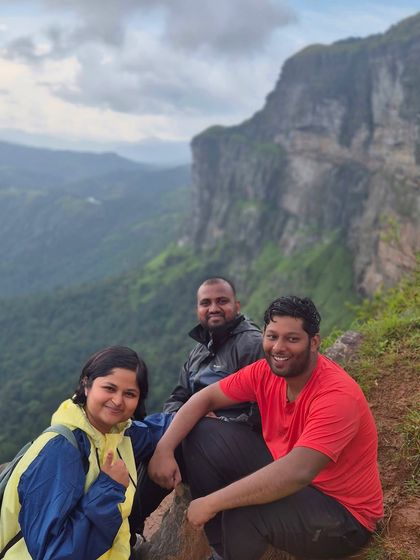 Three friends enjoying the view from a cliff edge on the Bandaje trail.