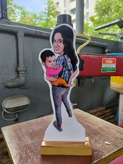 A mother and child caricature transformed into a miniature wooden cut-out. This is a sweet and personal keepsake that can be displayed on any desk or shelf.