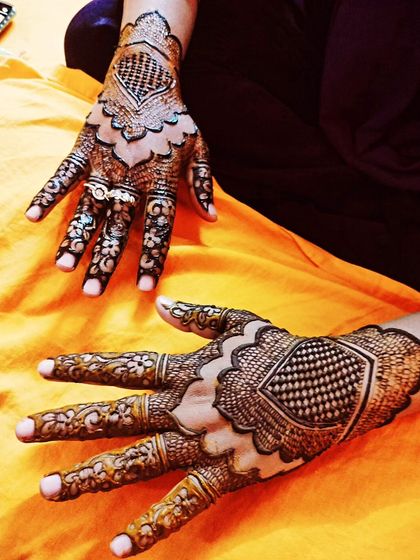 A two-hand view of the geometric Eid design, showing how the patterns complement each other.